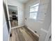 Bright laundry room with vinyl flooring and kitchen access at 2526 Pleasant W Way, Carmel, IN 46280