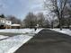 Residential street with snow-covered yards and homes at 2526 Pleasant W Way, Carmel, IN 46280