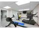 Bright gym features a variety of modern exercise equipment and a TV at 40 Wildwood Dr, Carmel, IN 46032