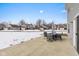 Private patio with table and chairs, overlooking a snow-covered yard at 4046 Stubbington Ln, Indianapolis, IN 46239