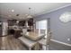 Kitchen and dining area with light wood table and bench at 4046 Stubbington Ln, Indianapolis, IN 46239