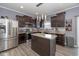 Modern kitchen with dark cabinets, island, and stainless steel appliances at 4046 Stubbington Ln, Indianapolis, IN 46239