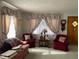 Living room with two armchairs, sofa, and floral curtains at 409 N 19Th Ave, Beech Grove, IN 46107