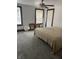 Bright bedroom with gray carpet, ceiling fan, and large windows at 448 N Gray St, Indianapolis, IN 46201