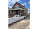 Brick home with front porch, steps, and a white wall at 448 N Gray St, Indianapolis, IN 46201