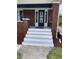 Front porch with painted steps and a security door at 448 N Gray St, Indianapolis, IN 46201
