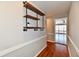 Bright hallway featuring hardwood floors and open shelving at 4722 Bluffwood N Dr, Indianapolis, IN 46228