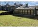 The backyard featuring a sunroom, skylights, and a serene view of the surrounding greenery at 5060 Hawthorne Way # 11, Avon, IN 46123