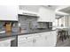 White kitchen cabinets, gray countertops, and a breakfast bar at 5060 Hawthorne Way # 11, Avon, IN 46123