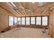 Spacious sunroom with wood paneling and exercise equipment at 5060 Hawthorne Way # 11, Avon, IN 46123