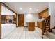 View of basement kitchenette open to living room, staircase, and tiled floors at 5508 Bay Landing Cir, Indianapolis, IN 46254