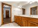 Bathroom showcasing dual sinks, wood cabinets, and access to other rooms at 5508 Bay Landing Cir, Indianapolis, IN 46254