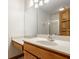 Bathroom featuring a vanity with marble countertop, a large mirror and wood trim at 5508 Bay Landing Cir, Indianapolis, IN 46254