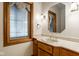 Bathroom features wood cabinets, white countertops, and a stylish mirror, reflecting quality craftsmanship at 5508 Bay Landing Cir, Indianapolis, IN 46254