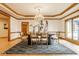 Elegant dining room featuring a modern chandelier, wood accents, and a stylish rug at 5508 Bay Landing Cir, Indianapolis, IN 46254