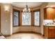 Bright breakfast nook with wood trimmed bay windows, hardwood floors, and chandelier at 5508 Bay Landing Cir, Indianapolis, IN 46254