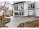 Exterior shot of the back of the home showcasing a paved patio area, large windows, and two sliding glass doors at 5508 Bay Landing Cir, Indianapolis, IN 46254