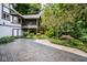 An exterior view showcases the home's deck, screened porch, beautiful landscaping, and hardscaped driveway at 5508 Bay Landing Cir, Indianapolis, IN 46254