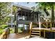 A view of the home's deck, which has wood rails, stairs, and a screened-in porch at 5508 Bay Landing Cir, Indianapolis, IN 46254