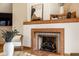 Living room fireplace with orange tile surround and hearth, with decorative tile accents, topped with display shelf at 5508 Bay Landing Cir, Indianapolis, IN 46254