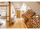Grand foyer features hardwood floors, natural light, a unique staircase, and a welcoming entryway at 5508 Bay Landing Cir, Indianapolis, IN 46254