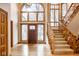 The foyer has wood floors, a stairway and a front door with custom glasswork at 5508 Bay Landing Cir, Indianapolis, IN 46254