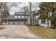 Charming two-story gray home features a three-car garage and mature trees at 5508 Bay Landing Cir, Indianapolis, IN 46254