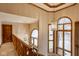 Elegant hallway features wooden railings, natural light, and arched windows for a timeless appeal at 5508 Bay Landing Cir, Indianapolis, IN 46254