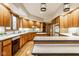 Spacious kitchen featuring warm wood cabinets, island, and modern appliances with hardwood floors at 5508 Bay Landing Cir, Indianapolis, IN 46254