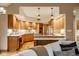 Open concept kitchen with warm wood cabinets, an island, and sight lines to the living room at 5508 Bay Landing Cir, Indianapolis, IN 46254
