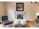 Close-up of the living room's fireplace with a modern tile design and stylish decor at 5508 Bay Landing Cir, Indianapolis, IN 46254