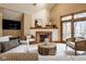 Cozy living room featuring a unique fireplace, comfortable seating, and natural light at 5508 Bay Landing Cir, Indianapolis, IN 46254
