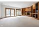 Spacious living room with brick fireplace, built-in shelving, and sliding glass doors to the outdoors at 5508 Bay Landing Cir, Indianapolis, IN 46254