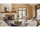 Cozy living room showcasing a tiled fireplace, hardwood floors, a wood-trimmed door, and comfortable furnishings at 5508 Bay Landing Cir, Indianapolis, IN 46254