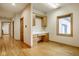 Bright, home office boasts built-in desk and storage space with natural light from a large window at 5508 Bay Landing Cir, Indianapolis, IN 46254
