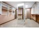 Large walk-in closet featuring custom shelving, a full-length mirror and plush carpeting at 5508 Bay Landing Cir, Indianapolis, IN 46254