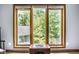 Bright window view overlooking mature trees and greenery, framed in wood casing with neutral walls at 5508 Bay Landing Cir, Indianapolis, IN 46254