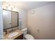 Small bathroom with granite vanity, toilet and mirror at 8207 Shorewalk Dr, Indianapolis, IN 46236