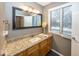 Bathroom with granite countertop and wood cabinets at 8207 Shorewalk Dr, Indianapolis, IN 46236