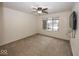 Spacious bedroom with carpeted floors, large window, and ceiling fan at 8207 Shorewalk Dr, Indianapolis, IN 46236