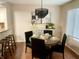 Round dining table with black chairs in a bright dining room at 8207 Shorewalk Dr, Indianapolis, IN 46236