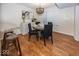 Bright dining room features hardwood floors, a round table with four chairs, and a sideboard at 8207 Shorewalk Dr, Indianapolis, IN 46236