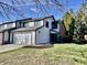 Charming two-story home with attached garage and freshly manicured lawn on a sunny day at 8207 Shorewalk Dr, Indianapolis, IN 46236