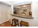 Kitchen features a breakfast bar with two stools and granite countertops at 8207 Shorewalk Dr, Indianapolis, IN 46236