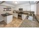 Updated kitchen with granite countertops and stainless steel appliances at 8207 Shorewalk Dr, Indianapolis, IN 46236