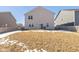 Large backyard with home view, partially covered in snow at 8576 Jeff Cir, Brownsburg, IN 46112