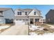 Two-story house with gray siding, brick accents, and a two-car garage at 8576 Jeff Cir, Brownsburg, IN 46112