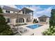 Inviting backyard featuring a sparkling pool, lounge chairs, umbrellas, and a covered patio for ultimate relaxation at 1461 Chatham Ridge Ct, Westfield, IN 46074