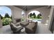 Relaxing covered patio with brick fireplace, chandelier, comfortable seating, overlooking the inviting pool at 1461 Chatham Ridge Ct, Westfield, IN 46074