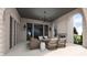 Relaxing covered patio with brick fireplace, chandelier, and comfortable seating, ideal for outdoor entertaining at 1461 Chatham Ridge Ct, Westfield, IN 46074